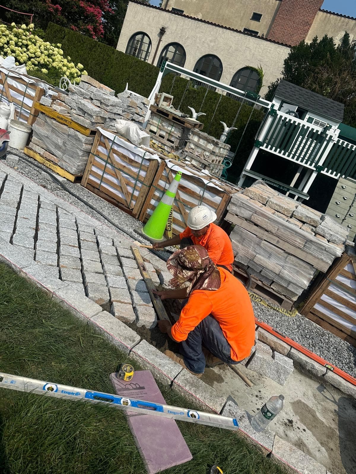 Our stonemasons hand-laying a granite cobblestone driveway